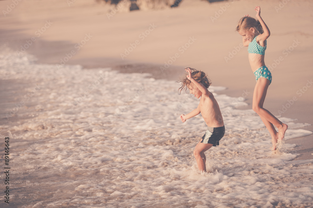 Fototapeta premium Two happy children playing on the beach