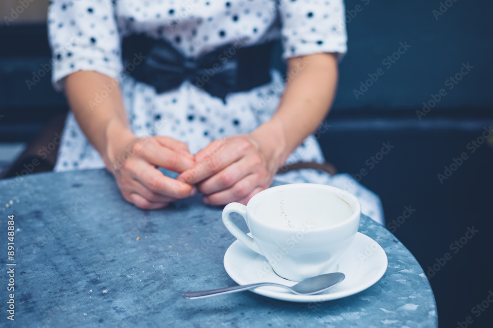 Woman at table with empty coffee cups Woman at table with empty coffee cups