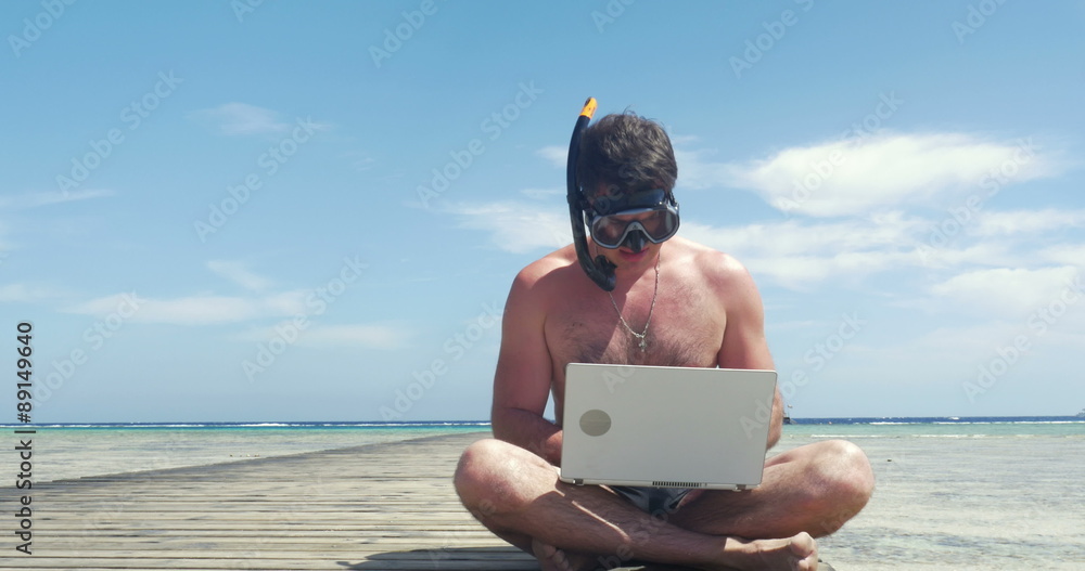 Busy Man in Snorkel and Mask with Laptop