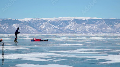 People travel on frozen Lake Baikal 
Extreme winter journey across the ice deep reservoir