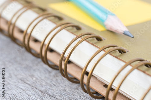  Ring Binder notebook with pencil on wooden.