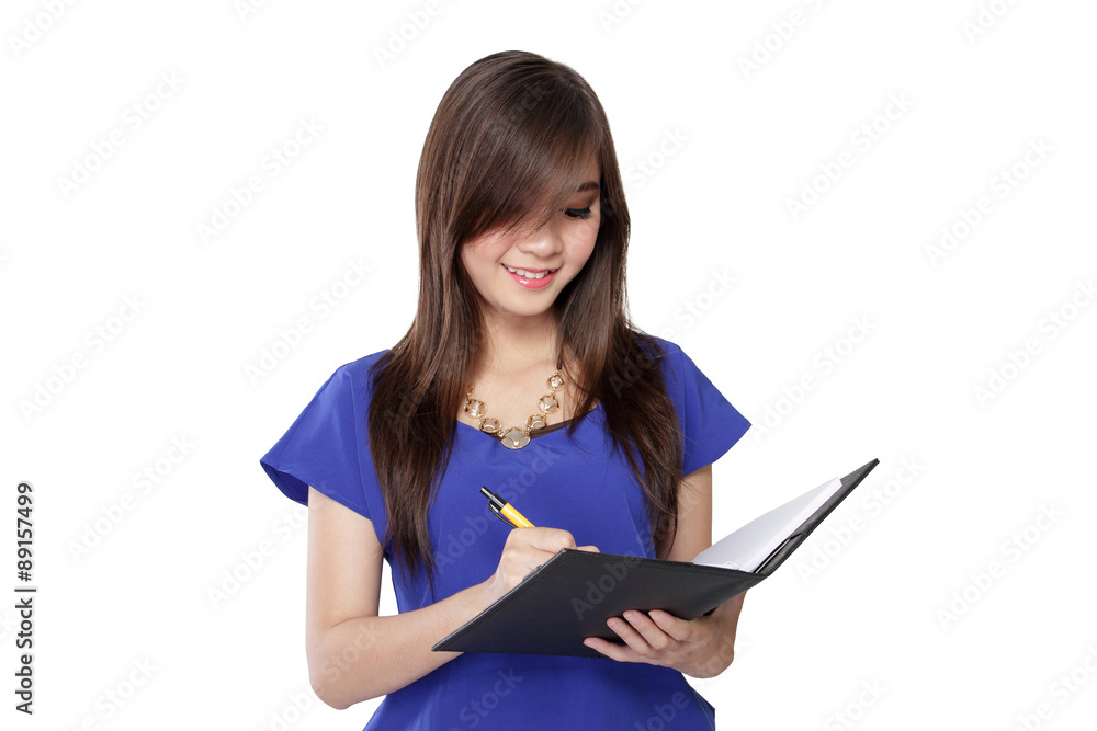 Pretty Asian girl write a note in a book Pretty Asian girl write a note in a book