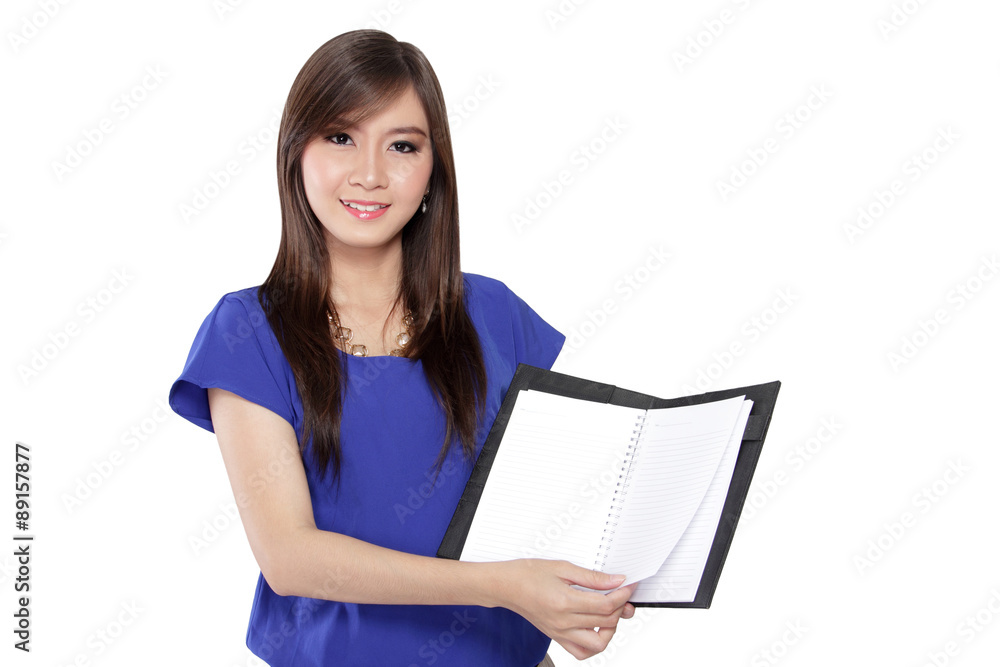 Asian girl showing an open book to camera Asian girl showing an open book to camera