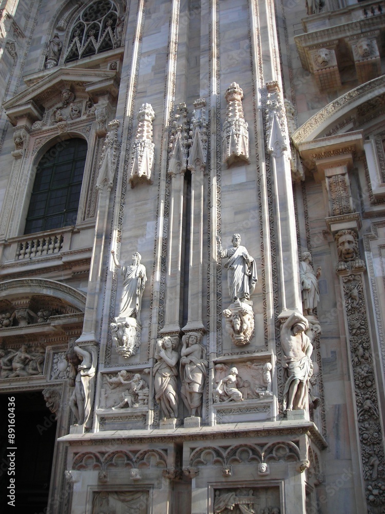 Fototapeta premium Details from the facade of Milan Cathedral (Duomo di MIlano), built in roch Gothic style in white marble.
