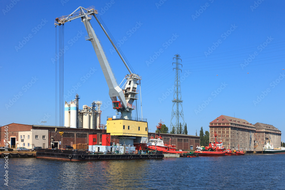 Huge floating crane moored at the wharf in port of Gdansk, Poland.