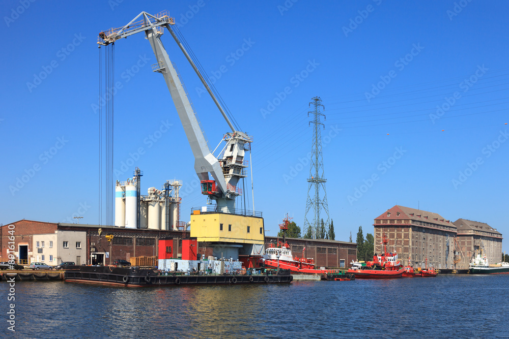 Huge floating crane moored at the wharf in port of Gdansk, Poland. Huge floating crane moored at the wharf in port of Gdansk, Poland.