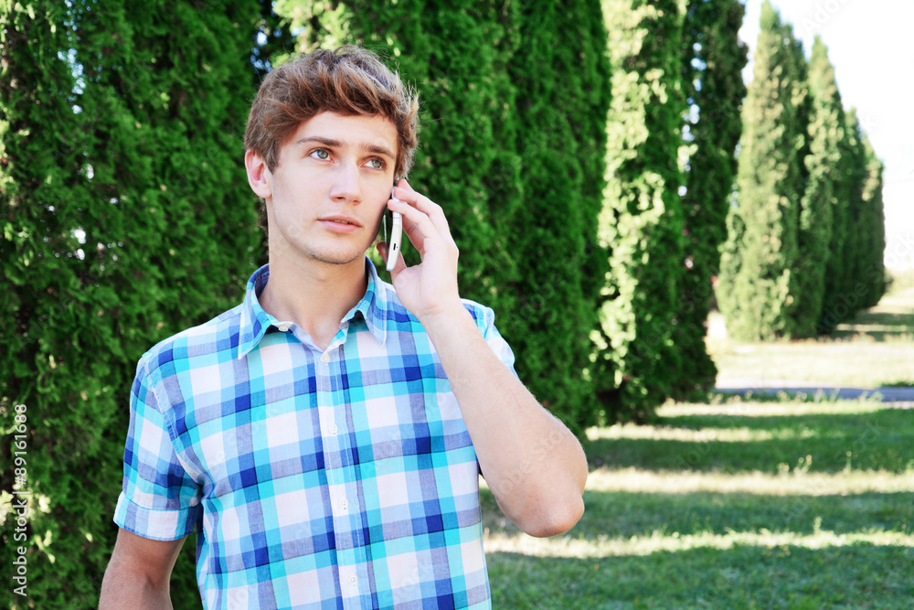 Young man is talking on the telephone Young man is talking on the telephone