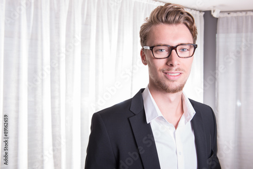 Portrait young business man in suit with glasses