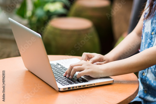 Woman hands typing on laptop