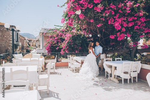 wedding couple in a cafe on summer terrace, Greece