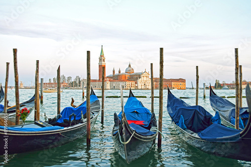 Gondolas moored by Saint Mark square with San Giorgio di Maggiore church in the background - Venice, Venezia, Italy, Europe © aimy27feb