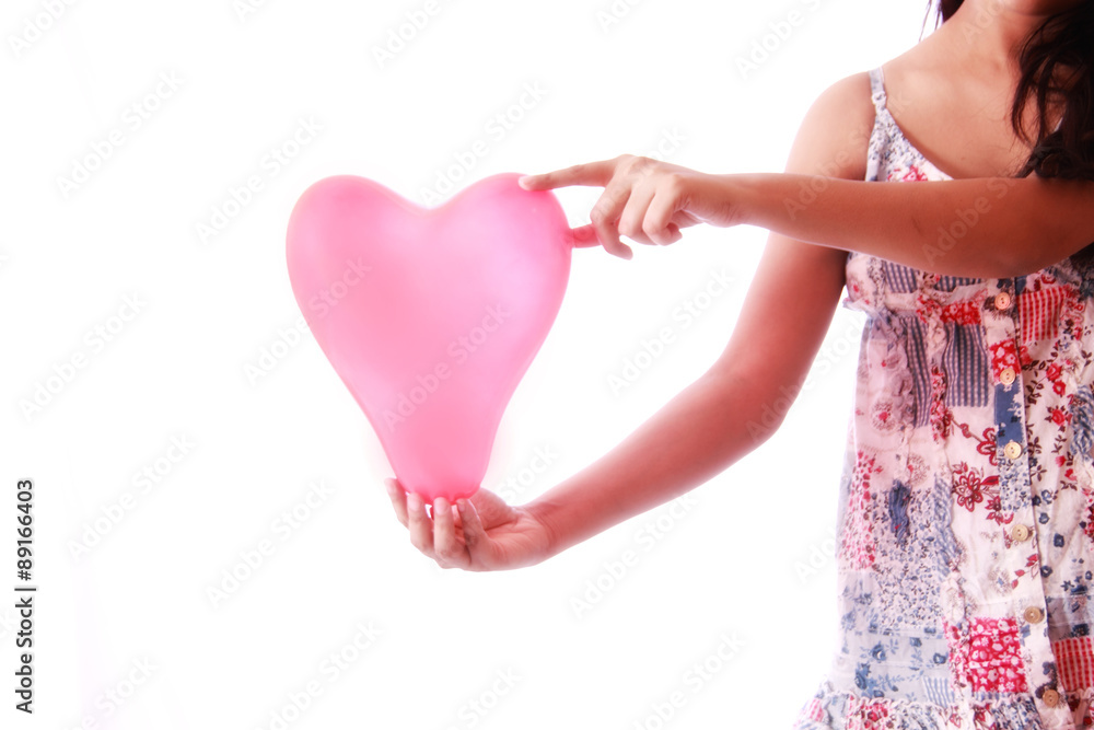 Young girl holding heart shape balloon , photographed against white background Young girl holding heart shape balloon , photographed against white background