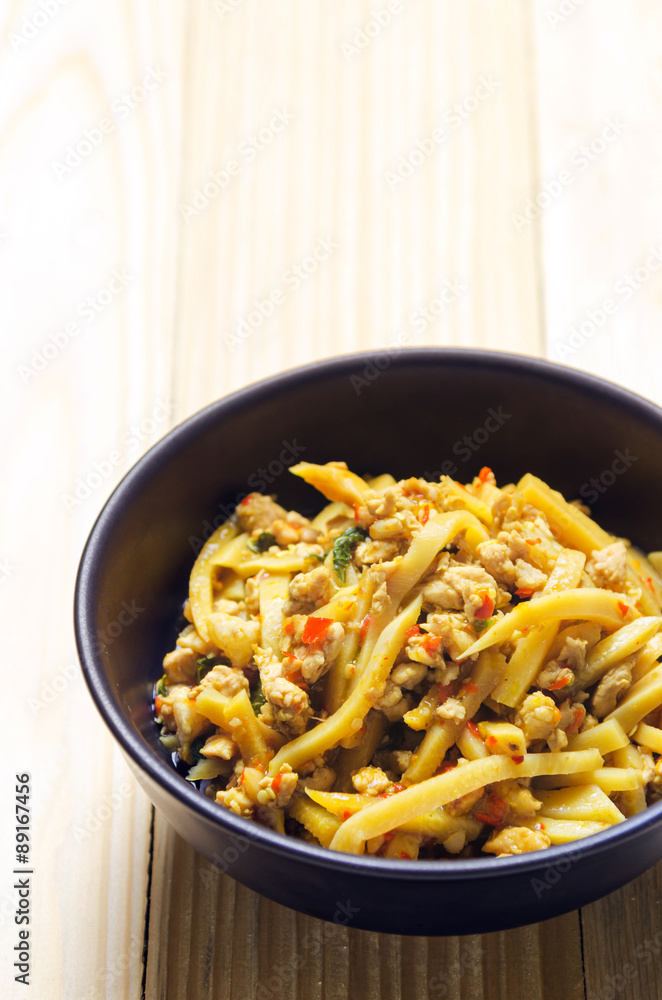 Thai spicy bamboo shoot salad on wooden table background Thai spicy bamboo shoot salad on wooden table background
