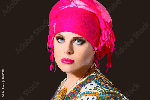 Portrait of beautiful  woman with turban on dark background