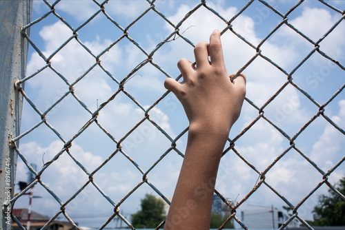 asian girl and  sad  hand hold jail