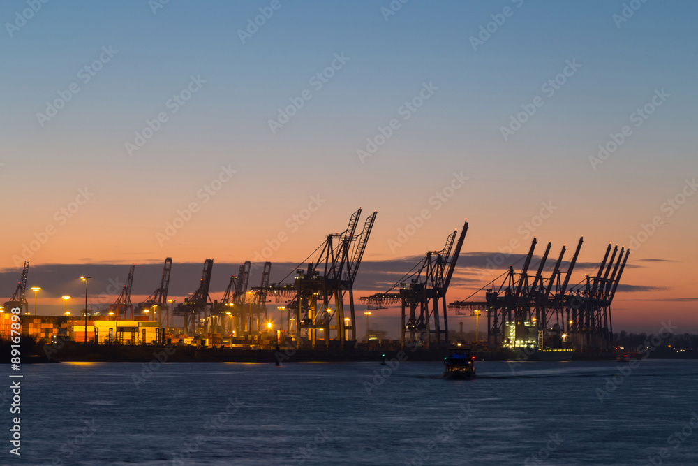 Cargo terminal in Port of Hamburg at dusk, Germany