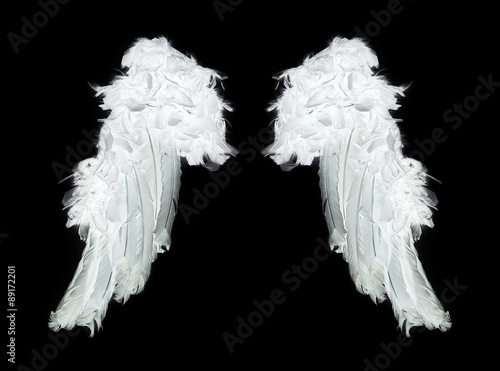 White angel wings on black background