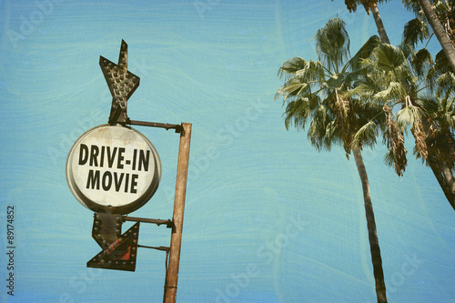 aged and worn vintage photo of drive in movies sign