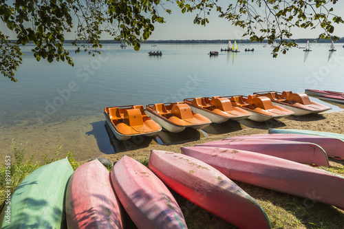 Fototapeta Naklejka Na Ścianę i Meble -  Colorful kayaks moored on lakeshore, Goldopiwo Lake, Mazury, Pol