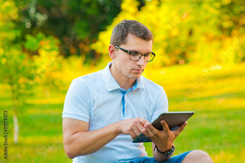 student with tablet outdoors
