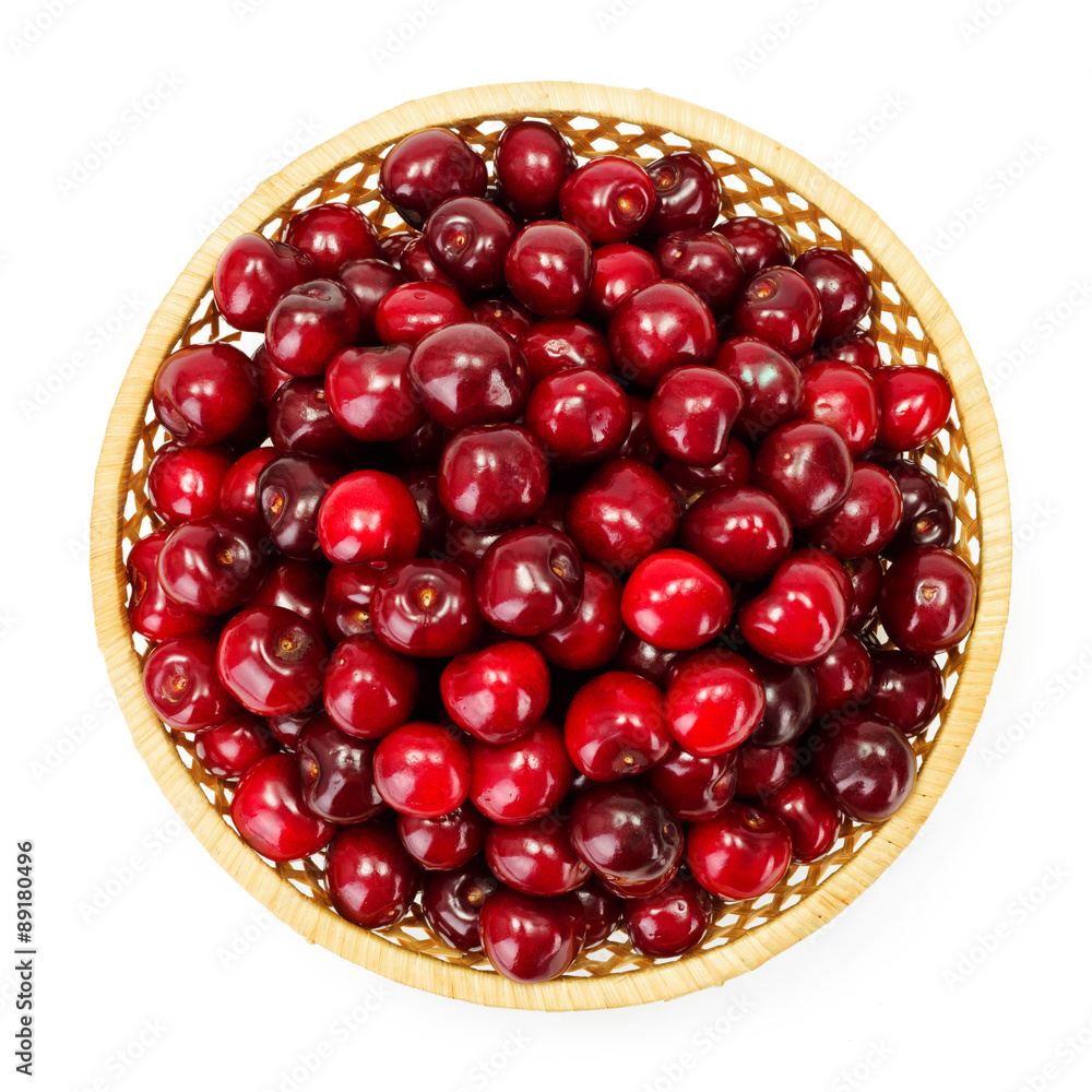 Top view of sweet cherry berries (Prunus avium) in wicker plate Top view of sweet cherry berries (Prunus avium) in wicker plate