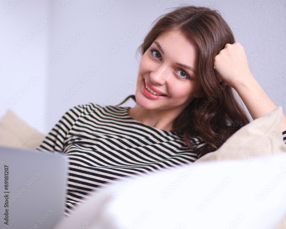 Happy pretty woman using laptop sitting on sofa Happy pretty woman using laptop sitting on sofa
