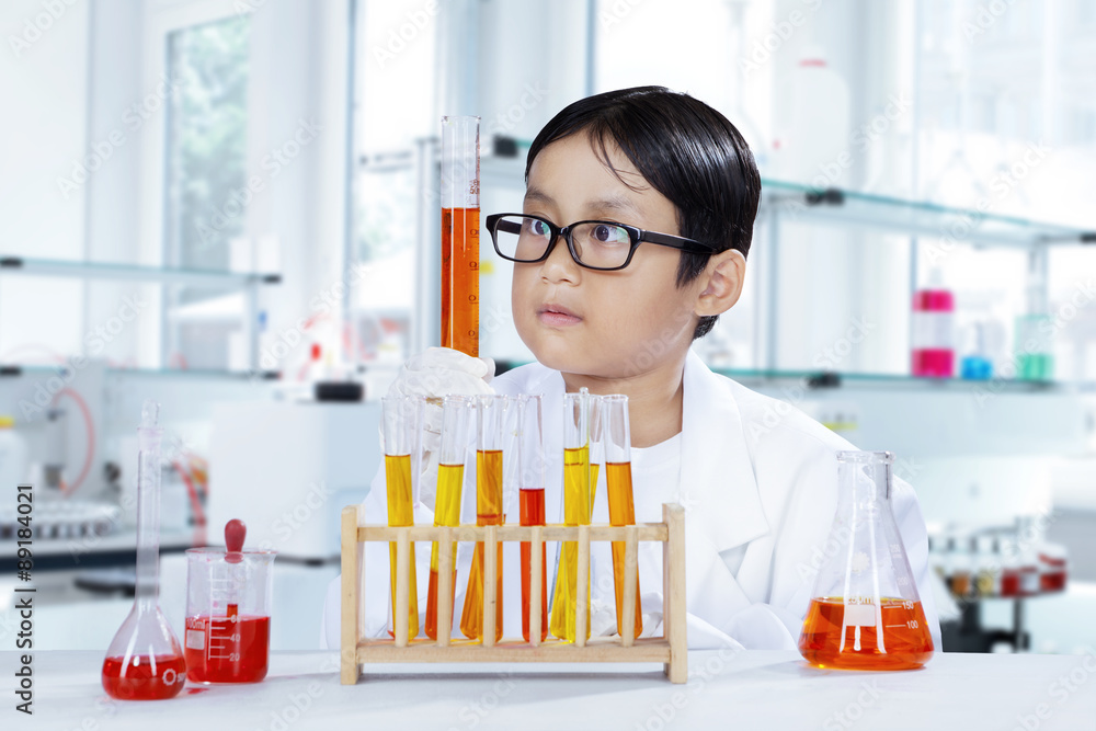 Cute boy doing chemical research in the lab Cute boy doing chemical research in the lab