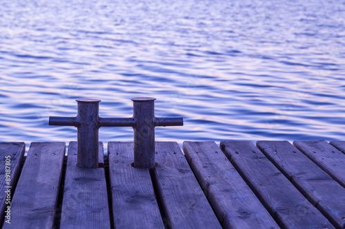 Rusty bollard on wooden pier