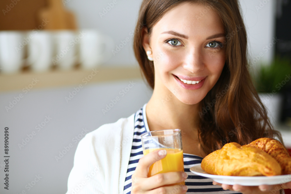 Young woman with glass of juice and cakes Young woman with glass of juice and cakes