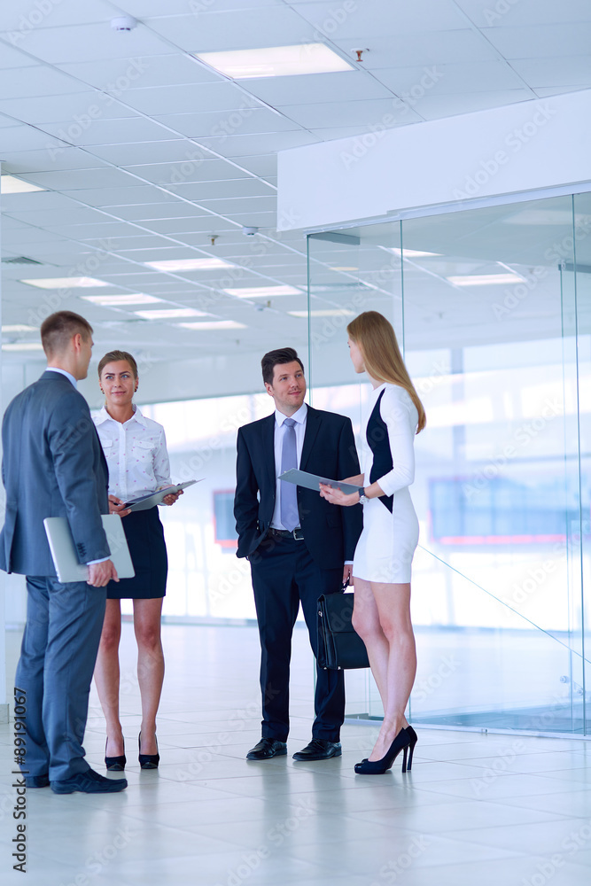 Smiling successful business team standing in office Smiling successful business team standing in office