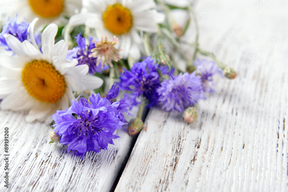 Fresh wildflowers on wooden table, closeup Fresh wildflowers on wooden table, closeup