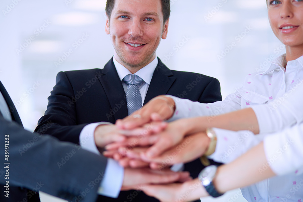 Fototapeta premium Business people with their hands together in a circle