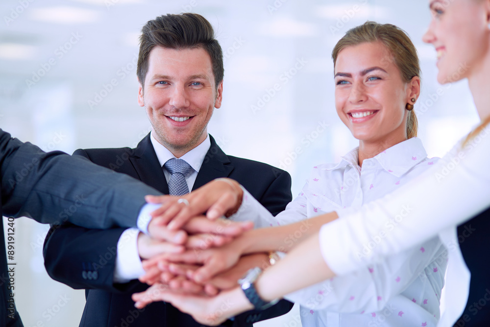 Business people with their hands together in a circle Business people with their hands together in a circle