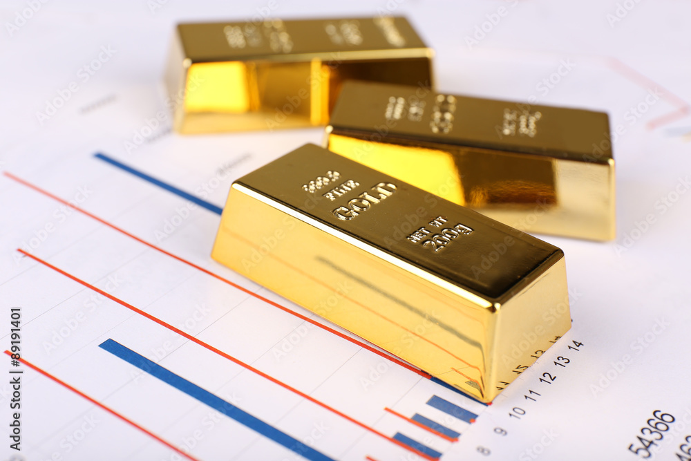 Gold bullion on documents background