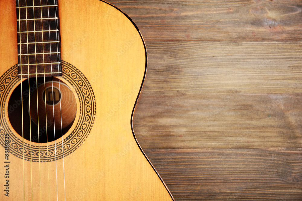 Fototapeta premium Acoustic guitar on wooden background