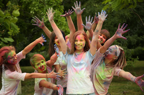 Young people celebrate Holi color festival in park © Africa Studio