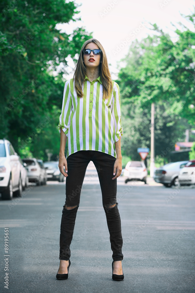 Fototapeta premium Beautiful young girl posing on city street