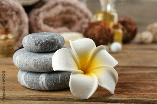 Stack of spa stones and spa treatment on wooden background