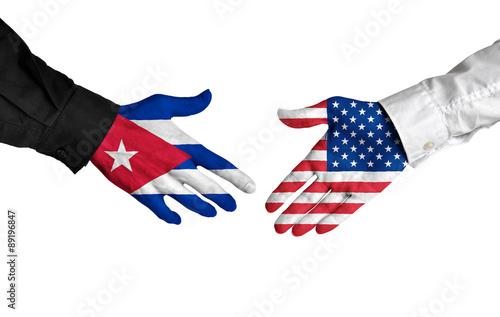 Cuban and American leaders shaking hands on a deal agreement