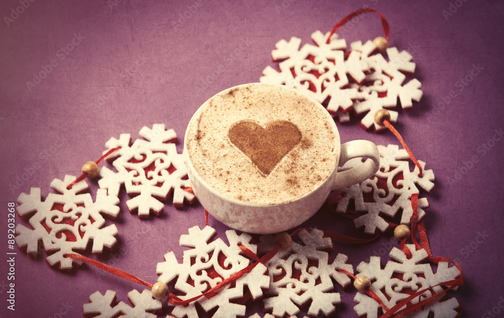 Cup of coffee with heart shape and snowflakes