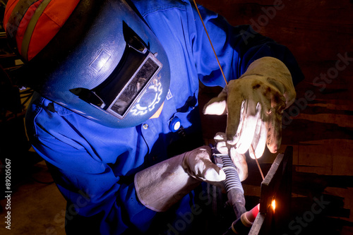 Worker is welding on the steel plate