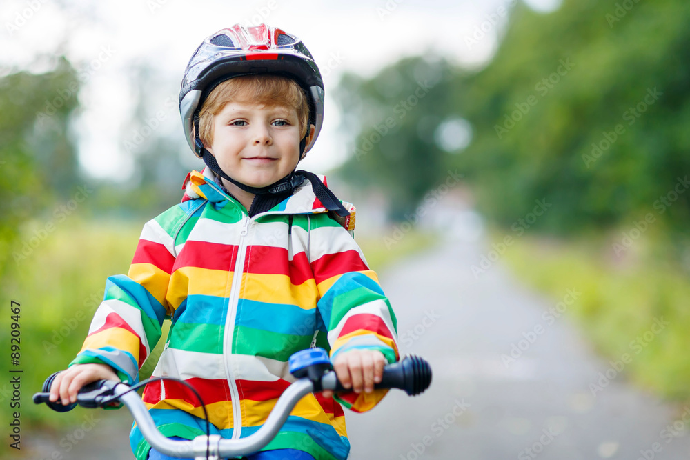 Portrait of funny cute kid with helmet on bicycle Portrait of funny cute kid with helmet on bicycle
