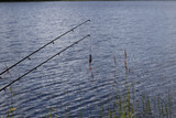 A lure and two rods in front of the water