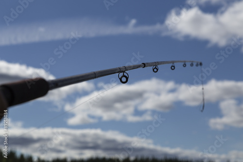 A closer look at a fishing rod with a sky in the background