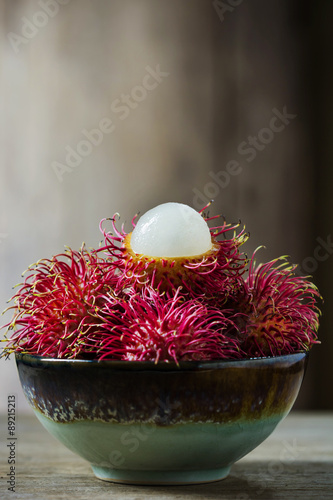 Red rambutan in ceramic bowl