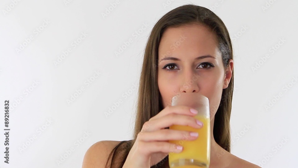 Young woman drinking a glass of orange juice Young woman drinking a glass of orange juice