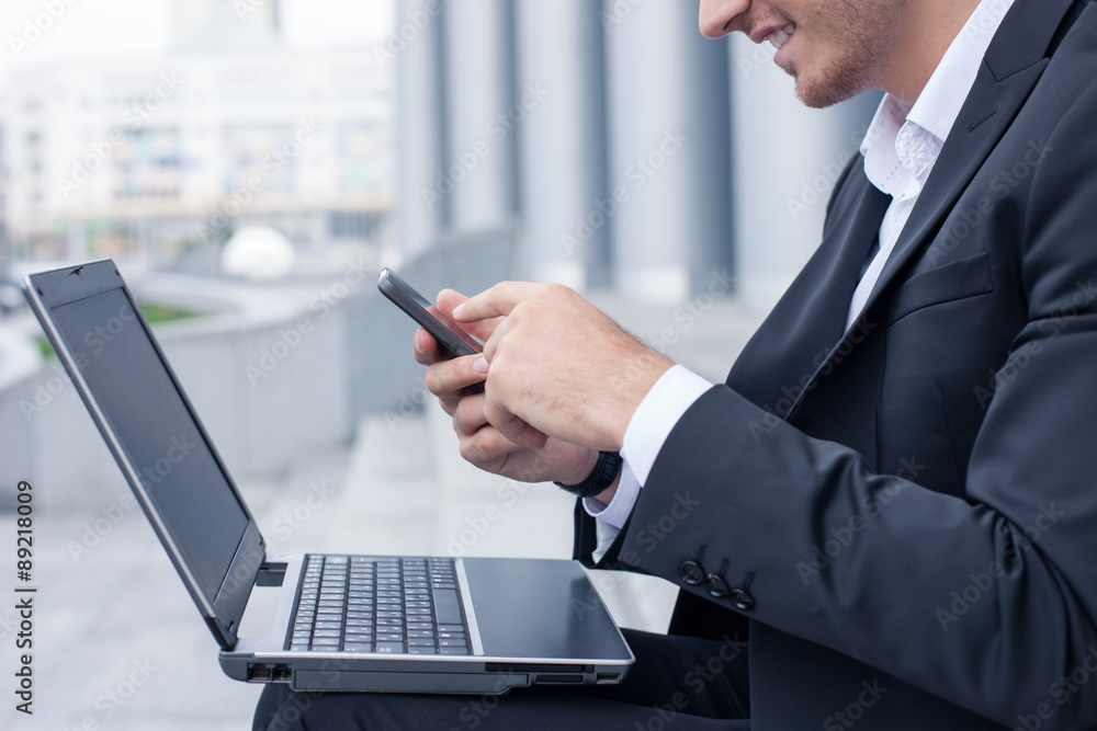 Successful man in suit is messaging to his business partner Successful man in suit is messaging to his business partner