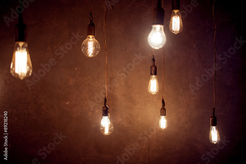 Vintage Lighting decor, lot of light bulbs hanging from the © Ulia Koltyrina