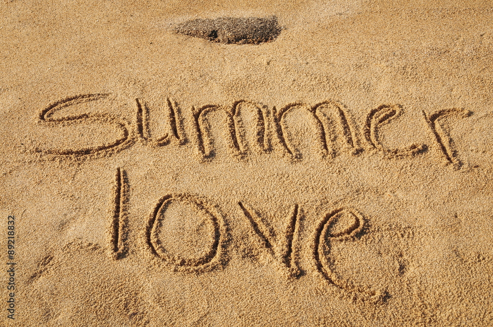 Fototapeta premium The words Summer Love written in the sand on the beach