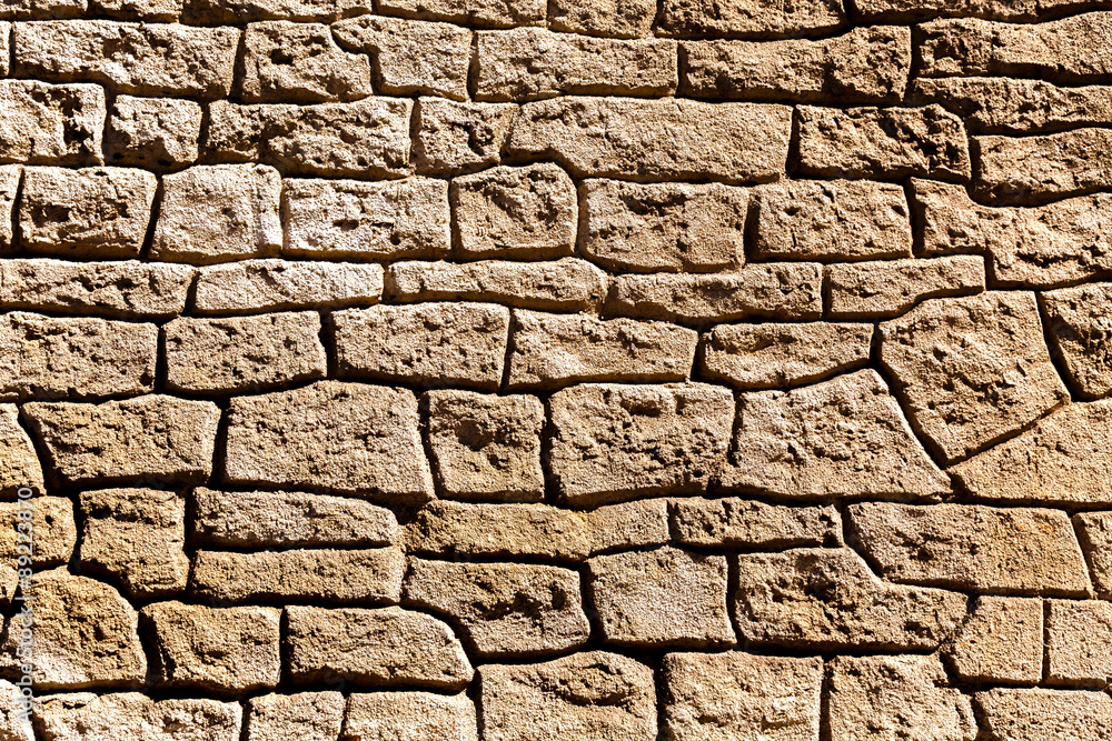 Fototapeta premium Detail of the structure of the old stone wall